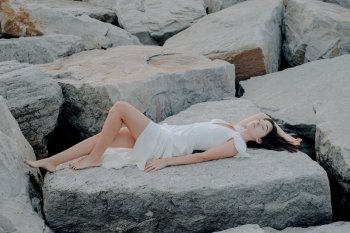 Constanza Barzola lying on rocks