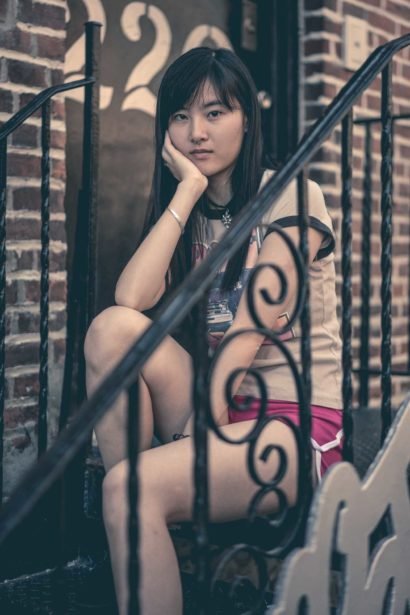 Barbie Qu sitting on steps
